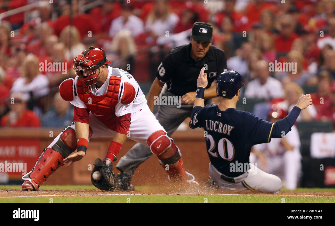 St. Louis Cardinals catcher A.J. Pierzynski takes the late throw as Milwaukee Brewers Jonathan Lucroy scores from second base on a double by Aramis Ramirez in the third inning at Busch Stadium in St. Louis on August 1, 2014. Making the call is umpire Phil Cuzzi. UPI/Bill Greenblatt Stock Photo