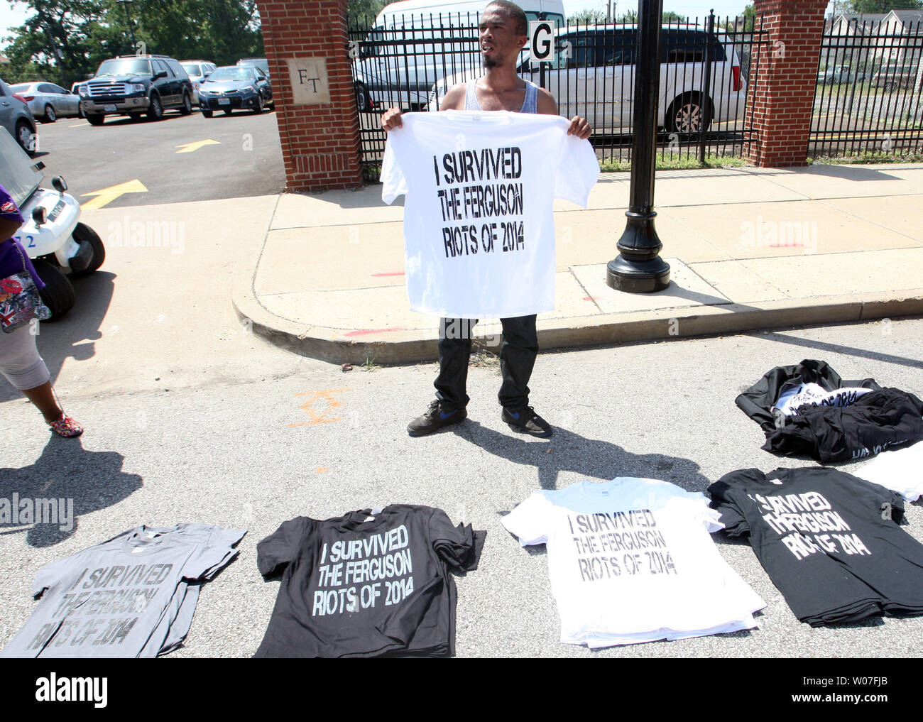A salesman sells "I survived the Ferguson riots of 2014"  tee shirts outside of the Friendly Temple Missionary Baptist Church during the funeral of Michael Brown Jr. in St. Louis on August 25, 2014. Brown gained attention after was shot by a white Ferguson, Missouri police officer on August 9 and was unarmed. The shooting led to several nights of looting, arrests and heavy police presence.   UPI/Bill Greenblatt Stock Photo