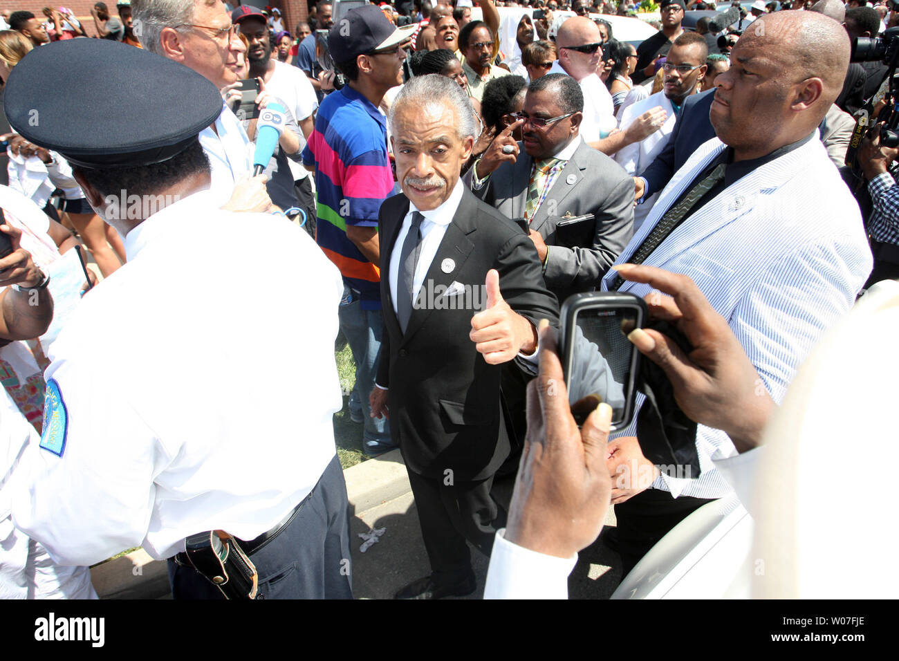 Rev. Al Sharpton gives a thumbs up as he leaves the Friendly Temple Missionary Baptist Church at the completion of the funeral for Michael Brown Jr. in St. Louis on August 25, 2014. Brown gained attention after was shot by a white Ferguson, Missouri police officer on August 9 and was unarmed. The shooting led to several nights of looting, arrests and heavy police presence.   UPI/Bill Greenblatt Stock Photo