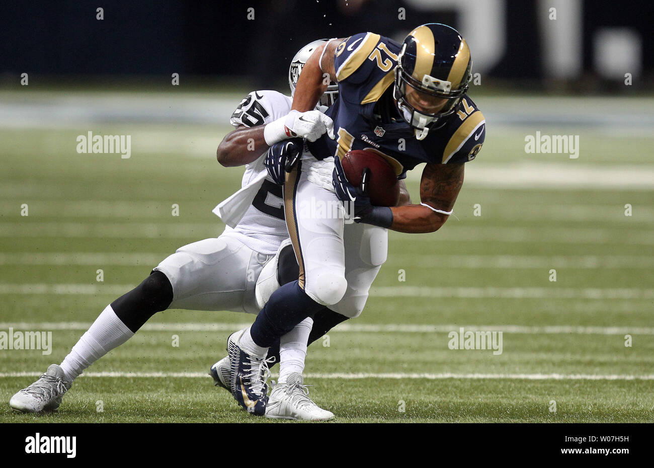 St. Louis Rams Stedman Bailey runs for a 12 yard gain as Oakland Raiders D.J. Hayden tries to drag him down in the first quarter at the Edward Jones Dome in St. Louis on November 30, 2014. St. Louis defeated Oakland 52-0.  UPI/Bill Greenblatt Stock Photo