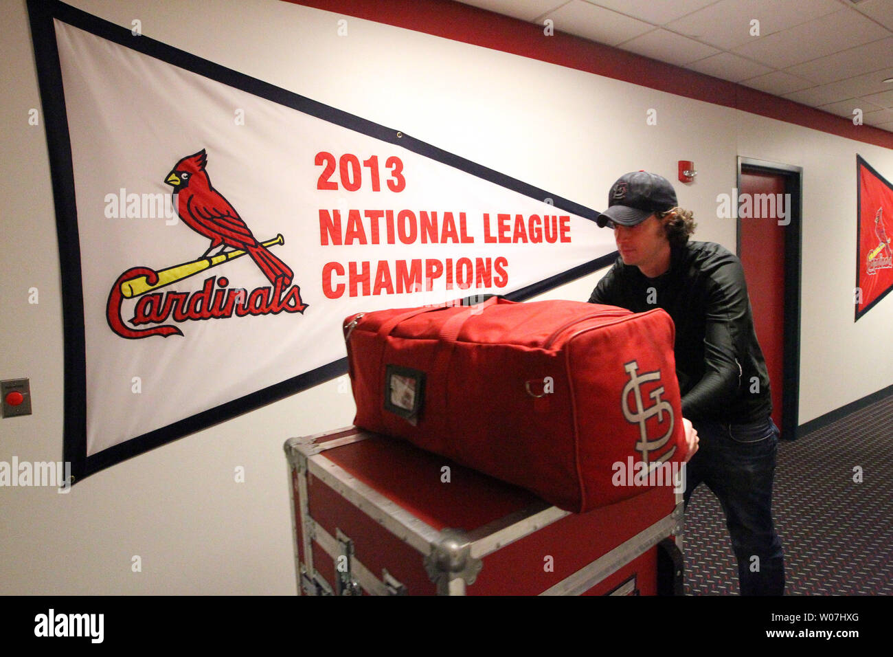 Cardinals clubhouse attendant Craig Wholke (R) and equiptment manager Rip  Rowan prepare to move luggage out of the clubhouse at Busch Stadium in St.  Louis on February 10, 2012, to a waiting