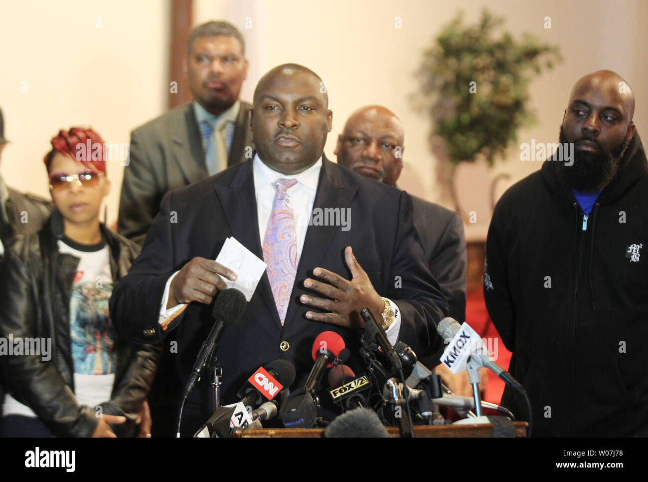 Lesley McSpadden, (L) and Michael Brown senior (R) the parents of Michael Brown, listen as family attorney Daryl Parks announce they plan to file a wrongful death lawsuit against the City of Ferguson and former Ferguson police officer Darren Wilson, in Ferguson,Missouri on March 5, 2015. The Department of Justice released their findings on March 4, 2015 saying no charges would be brought against Wilson for the shooting but was critical of the operations of the Ferguson Police Department.  Photo by Bill Greenblatt/UPI Stock Photo