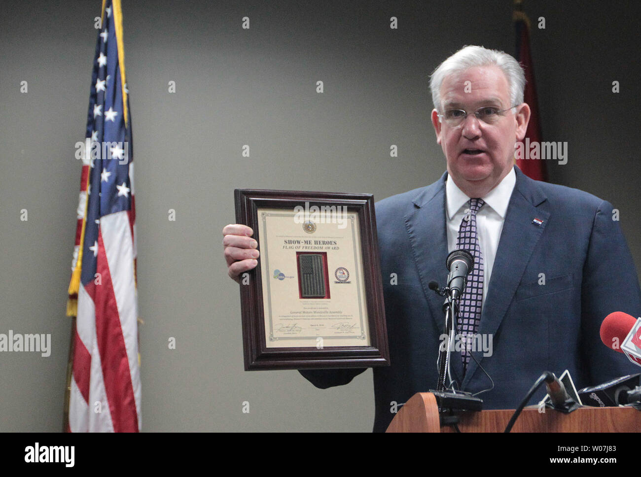 Missouri Governor Jay Nixon dispalys the Flag of Freedom award, he is presenting to the General Motors Assembly Plant in Wentzville, Missouri on March 9, 2015. The award recognizes the company’s commitment to hiring veterans through Missouri’s Show-Me Heroes program.The Flag of Freedom Award, which consists of a plaque featuring an American flag patch from the combat uniform of a member of the Missouri National Guard worn while that citizen-Soldier or Airman was deployed in Iraq or Afghanistan. Photo by Bill Greenblatt/UPI Stock Photo