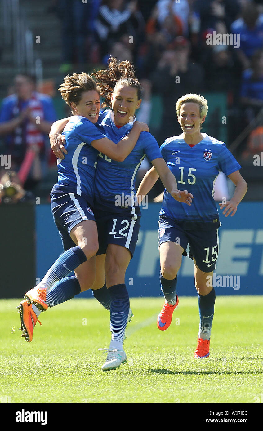 USA's Megan Klingenberg (L) jumps into the arms of teammate Lauren Holiday after scoring what would be the game winning goal in the first half against New Zealand at Busch Stadium in St. Louis on April 4, 2015. USA won the match 4-0. Photo by Bill Greenblatt/UPI Stock Photo