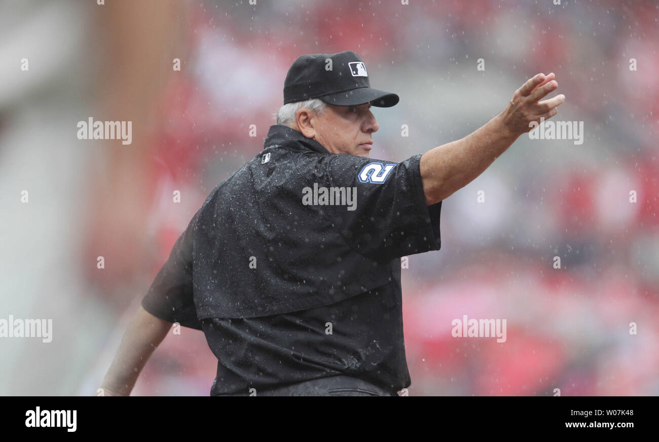Umpire Crew Chief Larry Vanover signals for the field to be cleared and