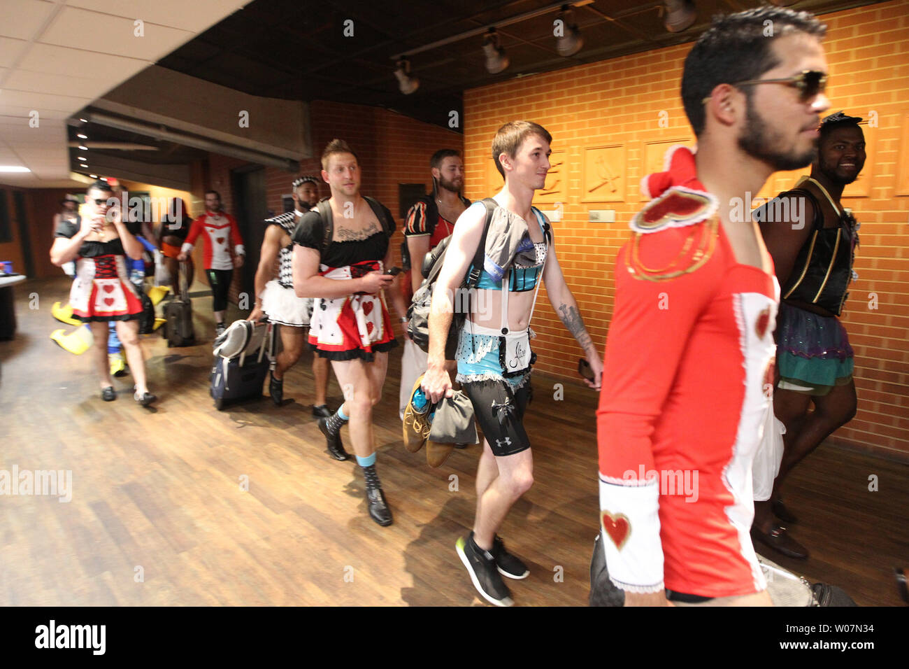 Rookie members of the Milwaukee Brewers walk to the bus in Alice in ...