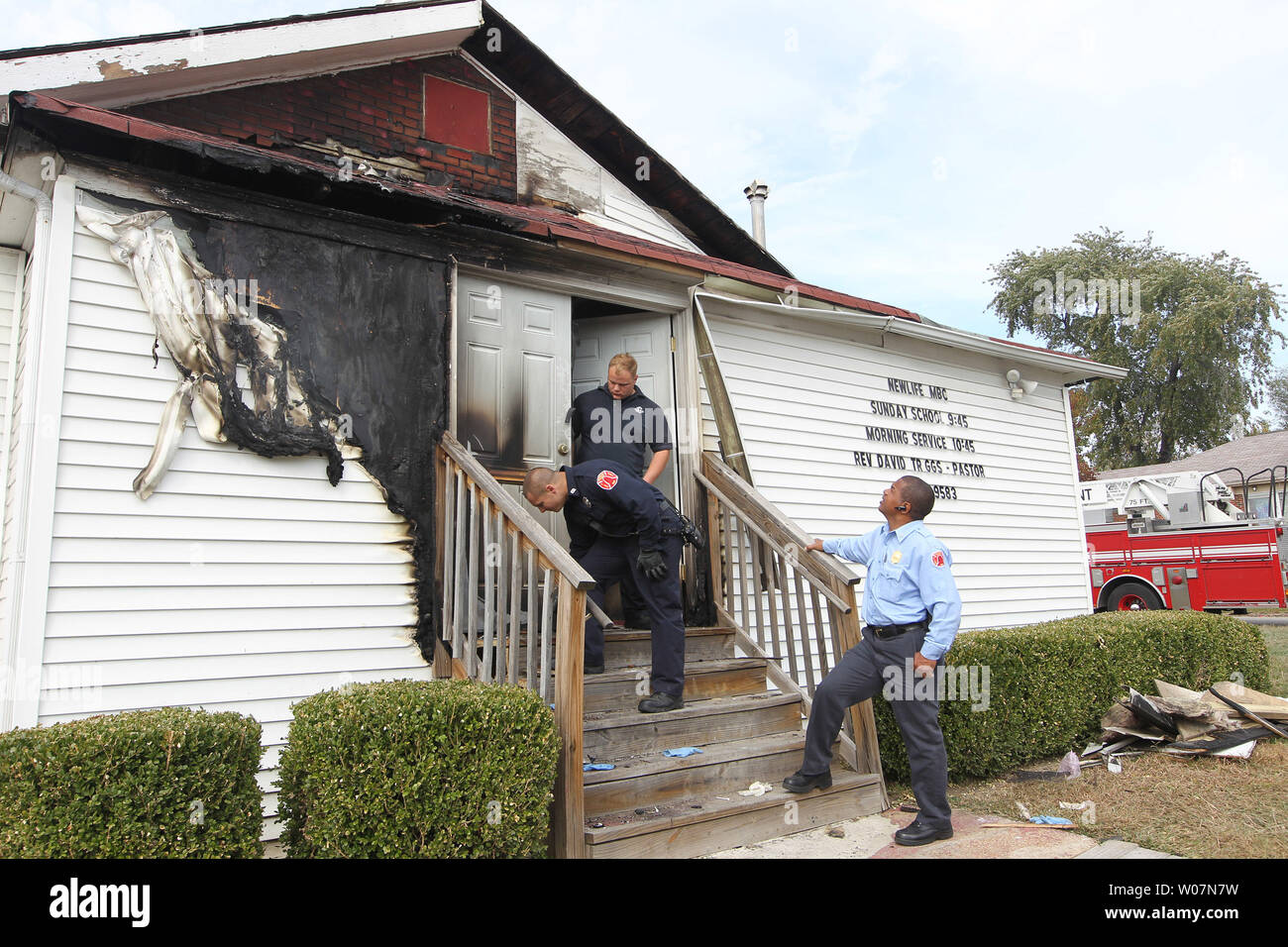 Members of Engine Company 27 of the St. Louis Fire Department inspect the outside of the Newlife Missionary Baptist Church in north St. Louis on October 20, 2015. An incendiary fire on October 17, 2015, damaged the front doors, siding and an entrance to the small Africian-American church. The fire is the sixth of its type in the the last two weeks. Police and the ATF have also been investigating the fires.    Photo by Bill Greenblatt/UPI Stock Photo