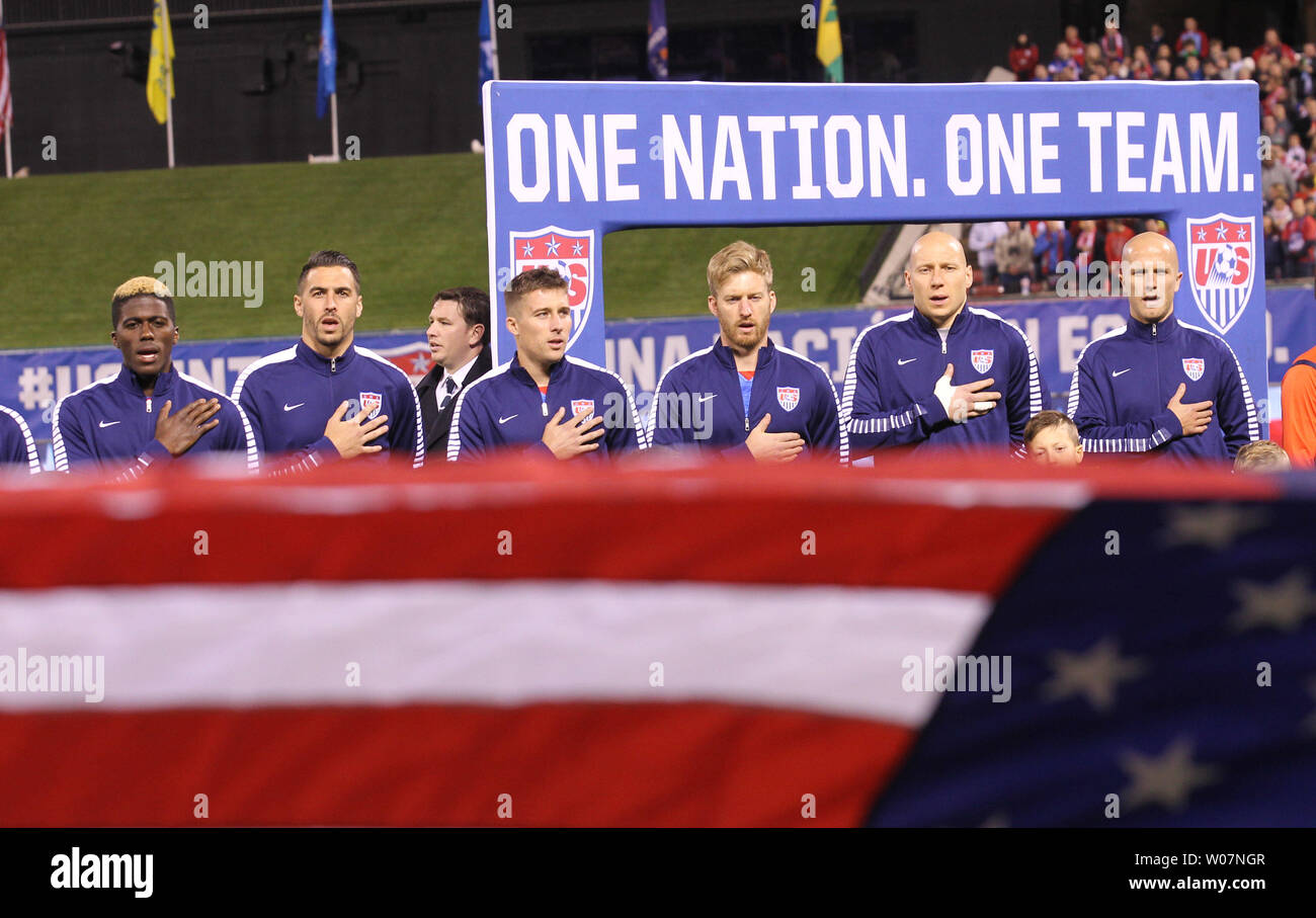 The USA Men's soccer team stand and sing during the playing of the