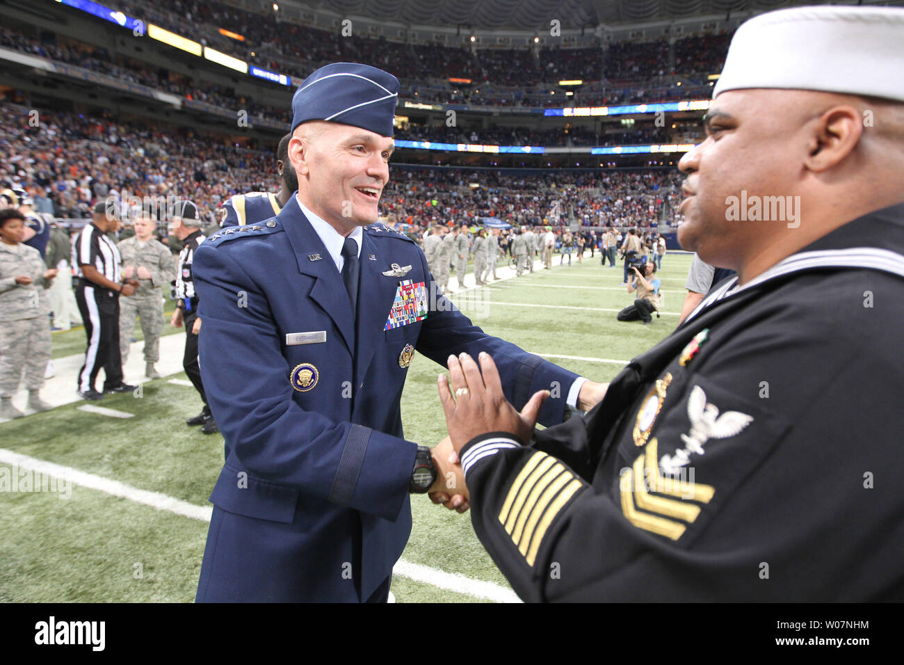 Gen. Carlton D. Everhart, Commander, Air Mobility Command, Scott Air Force Base, Illinois, (L) congratulates Navy recruiter 1st Class Gerald Wilson, Ret. after singing the National anthem before the Chicago Bears-St. Louis Rams football game at the Edward Jones Dome in St. Louis on November 15, 2015.   Photo by Bill Greenblatt/UPI Stock Photo