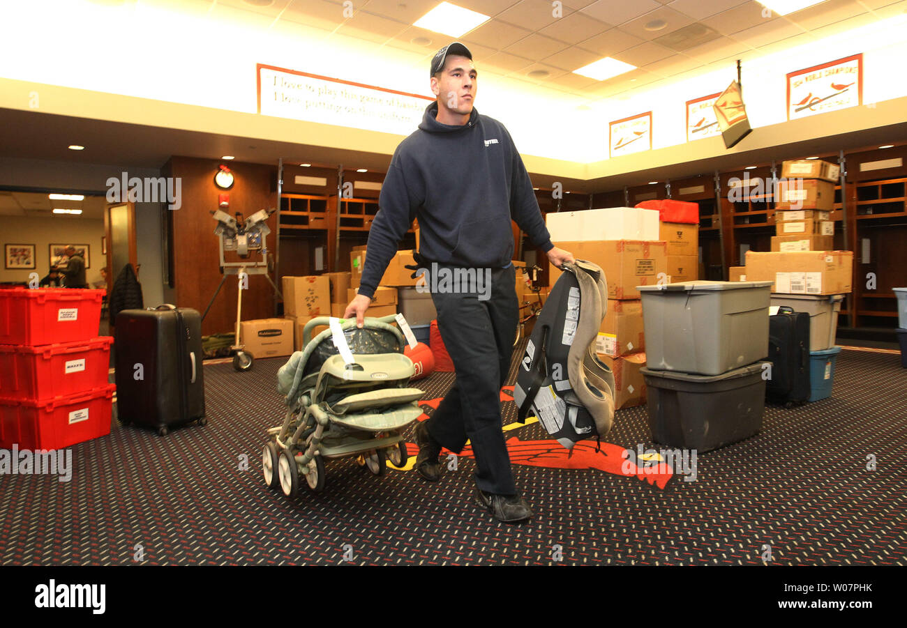Dustin Heddy of AMrazek Moving Systems moves a stroller and car seat