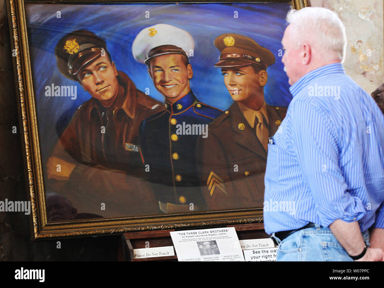 A visitor to the Soldiers Memorial Military Museum looks at the 1944 painting of 'The Three Clark Brothers', three area brothers in three different brances of service, before closing ceremonies of the facility in St. Louis on February 28, 2016. The building, which honors the lives of all those who have served in the military, is undergoing a major, $30 million, two year transformation.     Photo by Bill Greenblatt/UPI Stock Photo