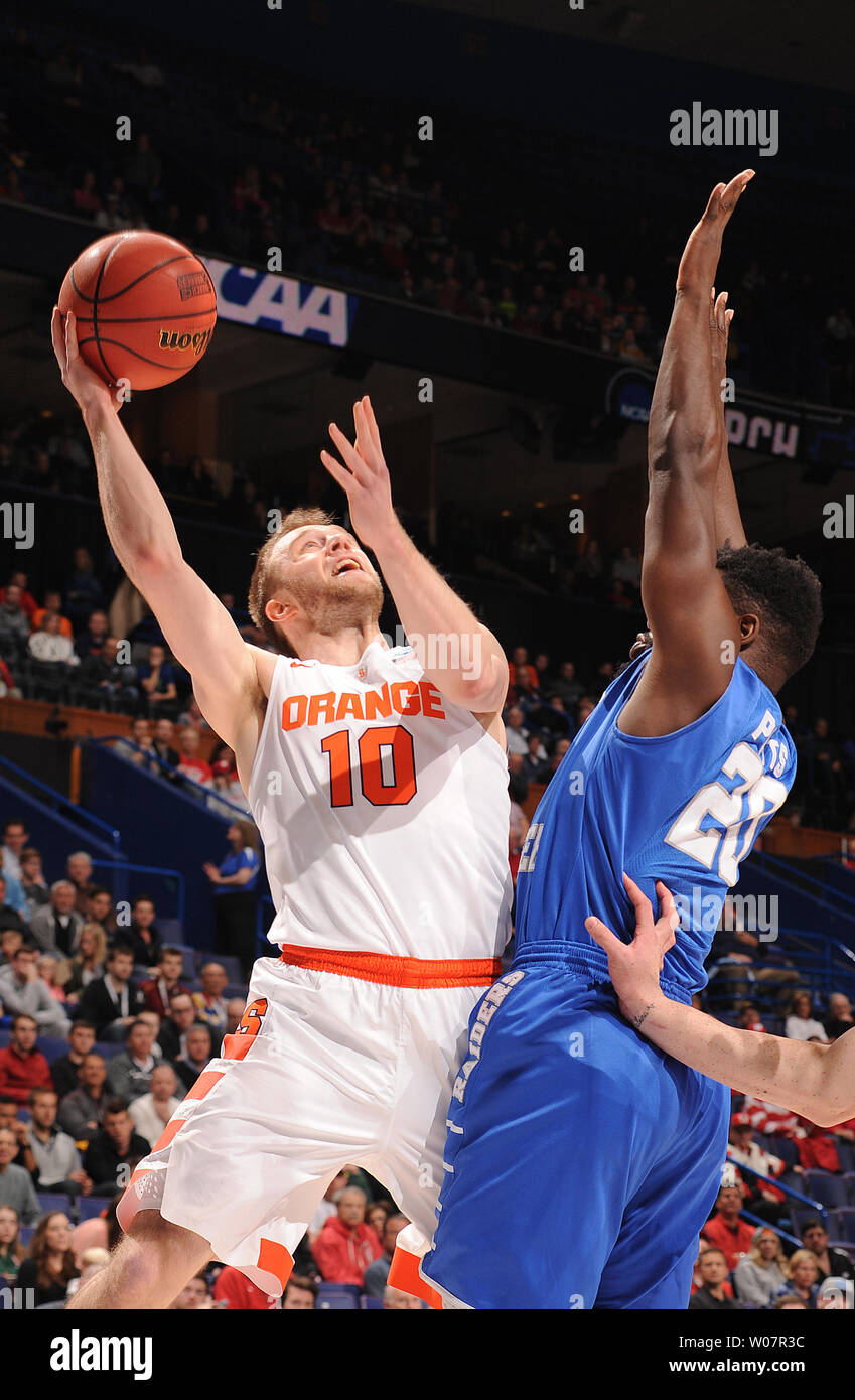 Syracuse's Trevor Cooney goes over Middle Tennessee's Giddy Potts for two points in the first half of the NCAA Division 1 Men's Basketball Championship at the Scottrade Center in St. Louis on March 20, 2016. Syracuse defeated Middle Tennessee 75-50.      Photo by Doug Devoe/UPI Stock Photo