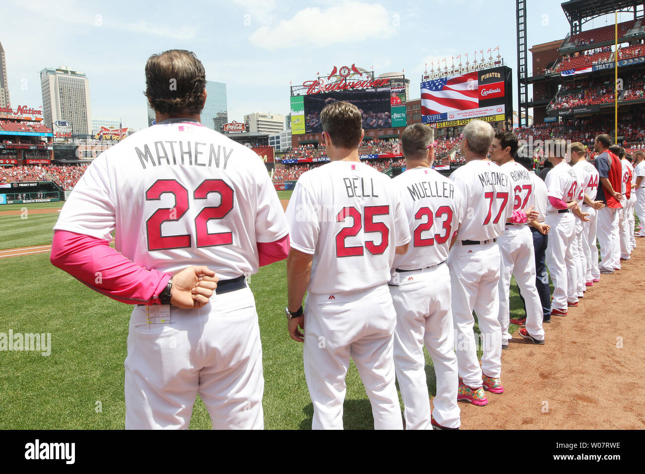 St. Louis Cardinals stand for the National Anthem, wearing pink