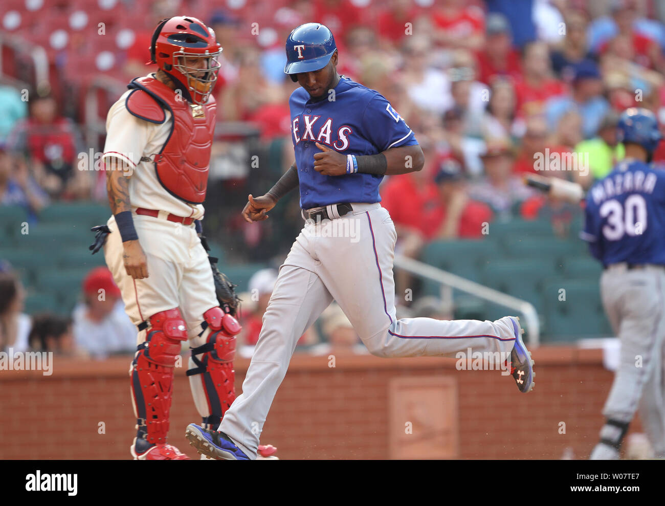 St. Louis Cardinals catcher Yadier Molina watches as Texas Rangers Jurickson Profarat cross home plate with the go ahead run in the ninth inning at Busch Stadium in St. Louis on June 18, 2016. Texas won the game 4-3.    Photo by Bill Greenblatt/UPI Stock Photo