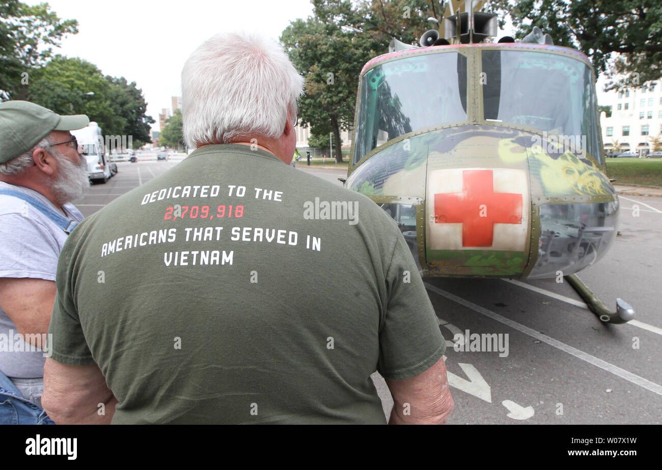 A worker explains the history of the 1967 Huey medical helicopter on display in downtown St. Louis on October 3, 2016. The helicopter is the 'Take Me Home Huey' Project, on tour of the United States. Artist Steve Maloney says the work is an ambassador that employs a piece of history for understanding and healing and is dedicated to the 2,709,918 Americans that served in Vietnam.The helicopter used for the sculpture was shot down in 1969 during a medical rescue in Vietnam.  Photo by Bill Greenblatt/UPI Stock Photo