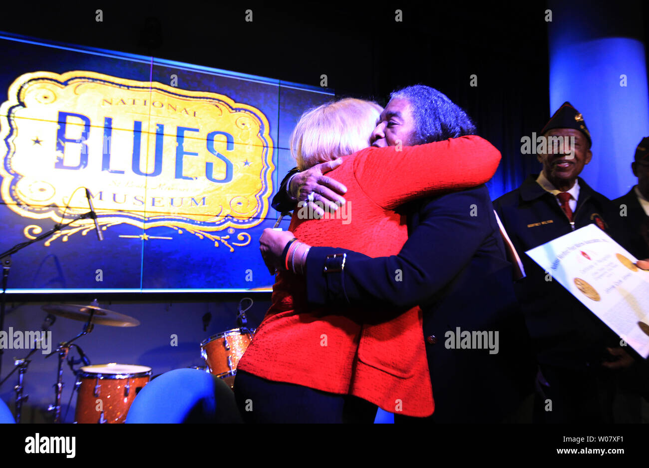 Frances Johnson, widow of the late jazz and blues pianist Johnnie Johnson is hugged by U.S. Senator Claire McCaskill after receiving the Congressional Gold Medal during a ceremony honoring her husband, at the National Blues Museum in St. Louis on November 28, 2016. Johnson, who lived in St. Louis, was a Montford Point Marine, the African-American Marines unit who endured racism and inspired social change while integrating the previously all-white Marine Corps during World War II. After his service, Johnson had a long musical career culminating with an induction into the Rock and Roll Hall of F Stock Photo