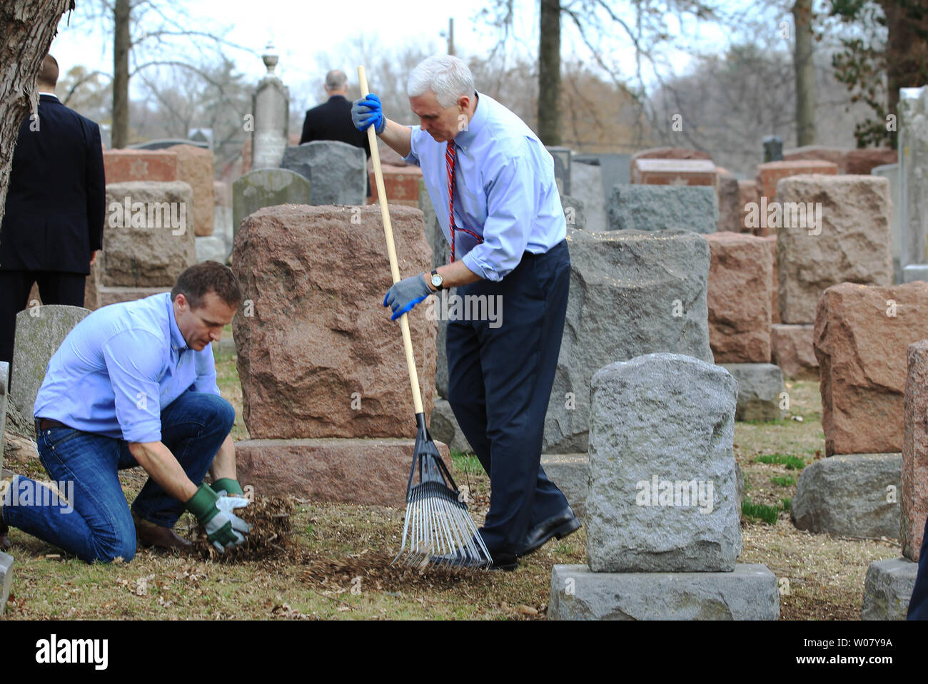 Vice President Mike Pence rakes leaves while Missouri Governor Eric Greitens picks them up at Chesed Shel Emeth Cemetery in University City on February 22, 2017. Vandals toppled nearly 200 headstones on February 20, 2017 in the Jewish cemetery. Pence who was in town for another event had asked to go to the cemetery for the large community cleanup that attracted over four thousand people.  Photo by Bill Greenblatt/UPI Stock Photo