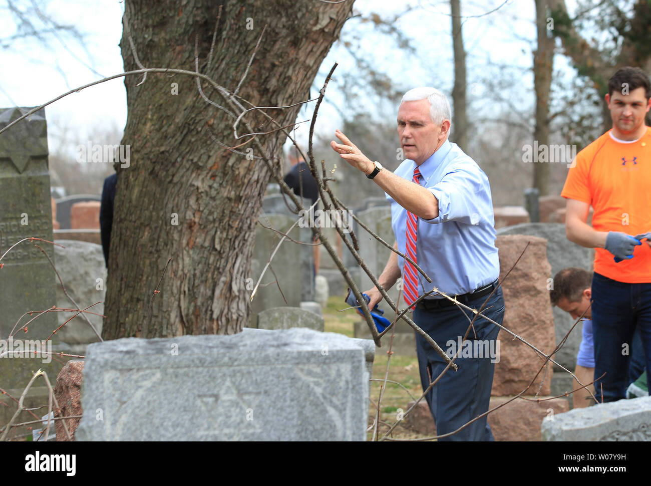 Vice President Mike Pence throws branches into a pile as he participates in a cleanup at Chesed Shel Emeth Cemetery in University City on February 22, 2017. Vandals toppled nearly 200 headstones on February 20, 2017 in the Jewish cemetery. Pence who was in town for another event had asked to go to the cemetery for the large community cleanup that attracted over four thousand people.  Photo by Bill Greenblatt/UPI Stock Photo