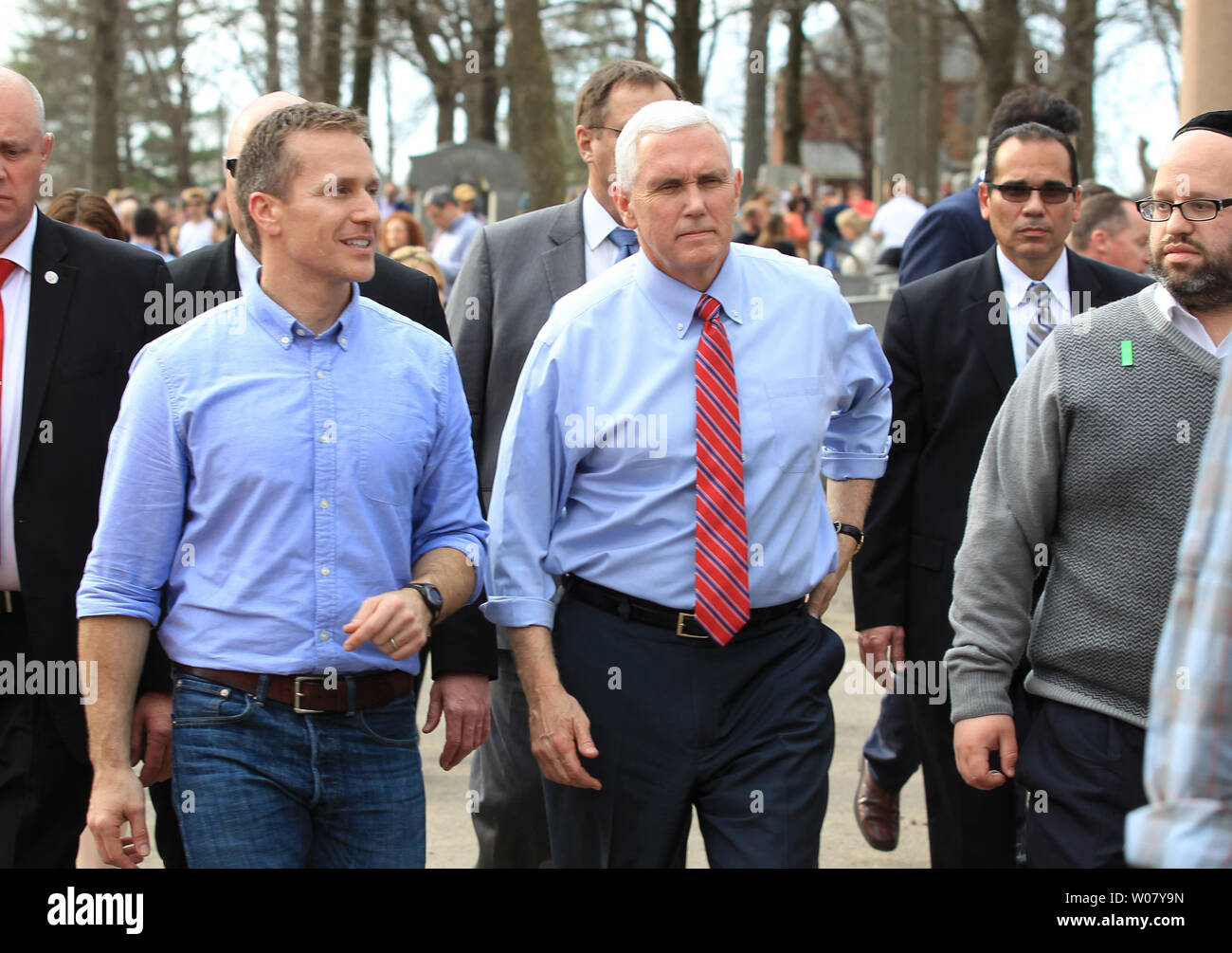Vice President Mike Pence walks with Missouri Governor Eric Greitens to clean up leaves and branches in the Chesed Shel Emeth Cemetery in University City on February 22, 2017. Vandals toppled nearly 200 headstones on February 20, 2017 in the Jewish cemetery. Pence who was in town for another event had asked to go to the cemetery for the large community cleanup that attracted over four thousand people.  Photo by Bill Greenblatt/UPI Stock Photo