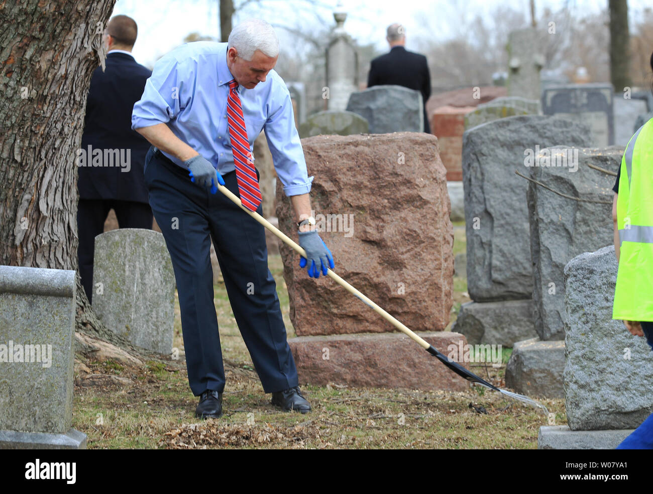 Vice President Mike Pence rakes leaves at Chesed Shel Emeth Cemetery in University City on February 22, 2017. Vandals toppled nearly 200 headstones on February 20, 2017 in the Jewish cemetery. Pence who was in town for another event had asked to go to the cemetery for the large community cleanup that attracted over four thousand people.  Photo by Bill Greenblatt/UPI Stock Photo