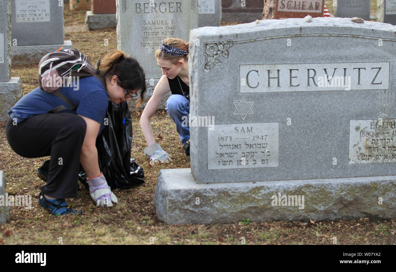Volunteers pickup yard waste during a hugh cleanup effort at Chesed Shel Emeth Cemetery in University City, Missouri on February 22, 2017. Vandals toppled nearly 200 headstones on February 20, 2017 prompting the community cleanup effort that attracted over four thousand people.  Photo by Bill Greenblatt/UPI Stock Photo