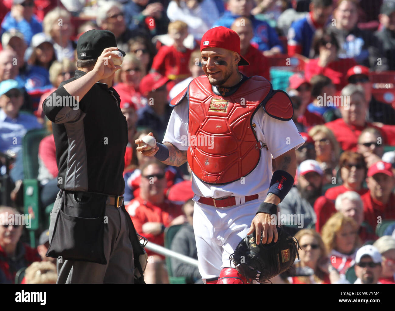 St. Louis Cardinals catcher Yadier Molina smiles to his bench as he