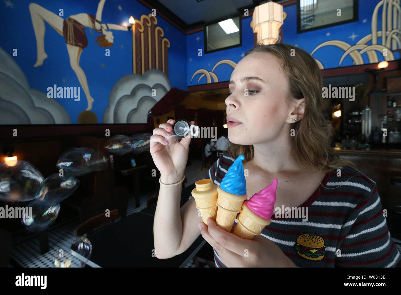 Teresa Strong, a server at the Fountain on Locust, checks her ice cream cone bubbles before celebrating a customers birthday on National Ice Cream Day in St. Louis on July 16, 2017. Photo by Bill Greenblatt/UPI Stock Photo