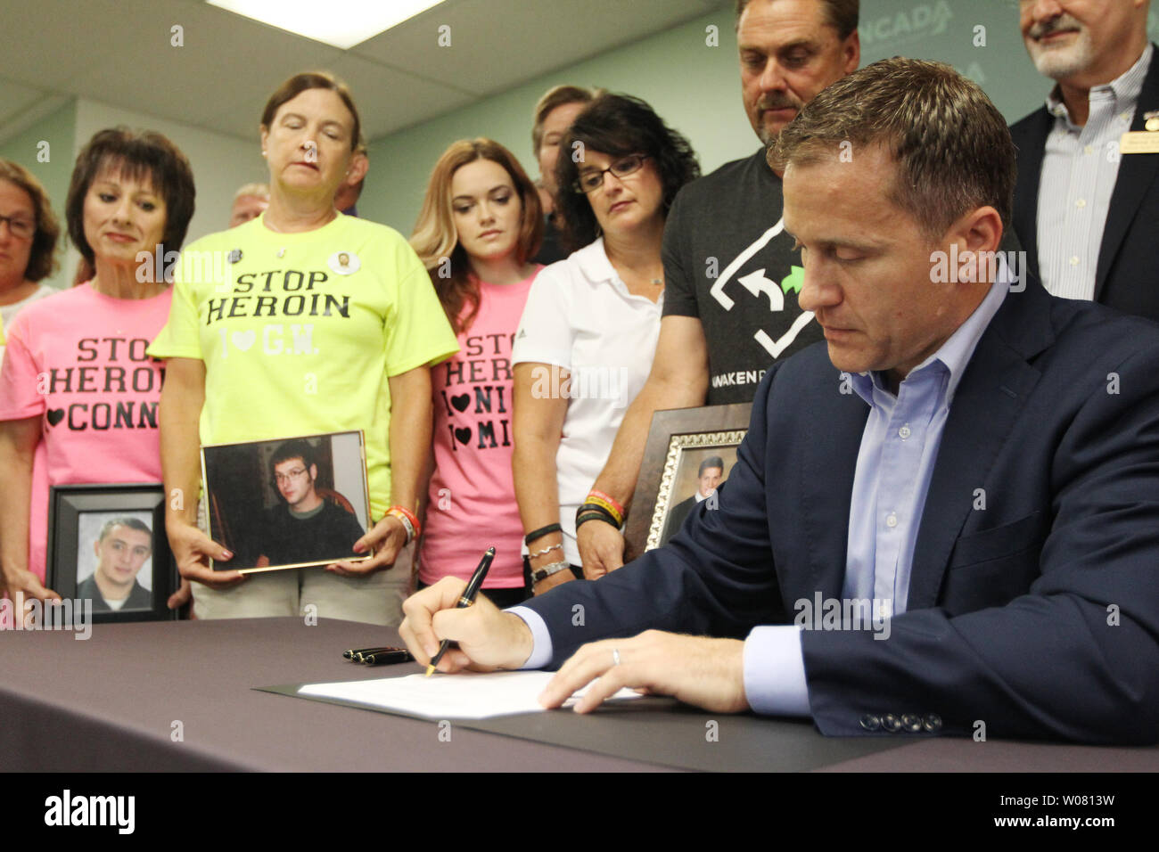 As parents of children who have died from heroin overdose look on ...
