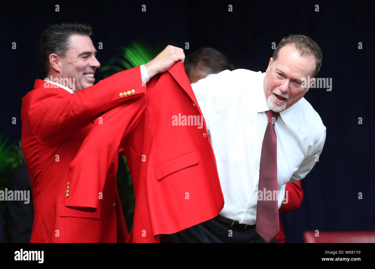 Newly inducted St. Louis Cardinals Hall of Fame member Mark McGwire tries on his new red jacket with the help of former teammate Jim Edmonds during the St. Louis Cardinals Hall of Fame Induction ceremonies in St. Louis on August 26, 2017. McGwire played 4 1/2 years with the Cardinals breaking Roger Maris' home run record, hitting 70 home runs in 1998 and is now the bench coach for the San Diego Padres.       Photo by Bill Greenblatt/UPI Stock Photo