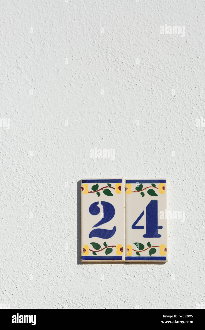 Traditional portuguese azulejo plates with numbers 2 and 4 on white wall Stock Photo