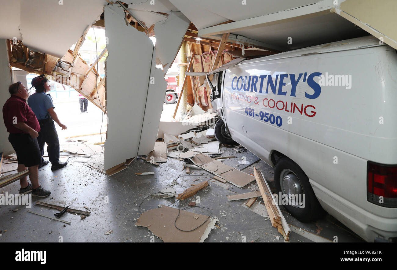 A St. Louis firefighter and building inspector check the interior of a building after a van crashed into the interior causing significant damage to the structure  in St. Louis on September 5, 2017. Officials say the driver may have expirenced a seizure moments before the crash. The driver was transported to a area hospital with non-life threating injuries while tenants of the building were safely evacuated. Photo by Bill Greenblatt/UPI Stock Photo