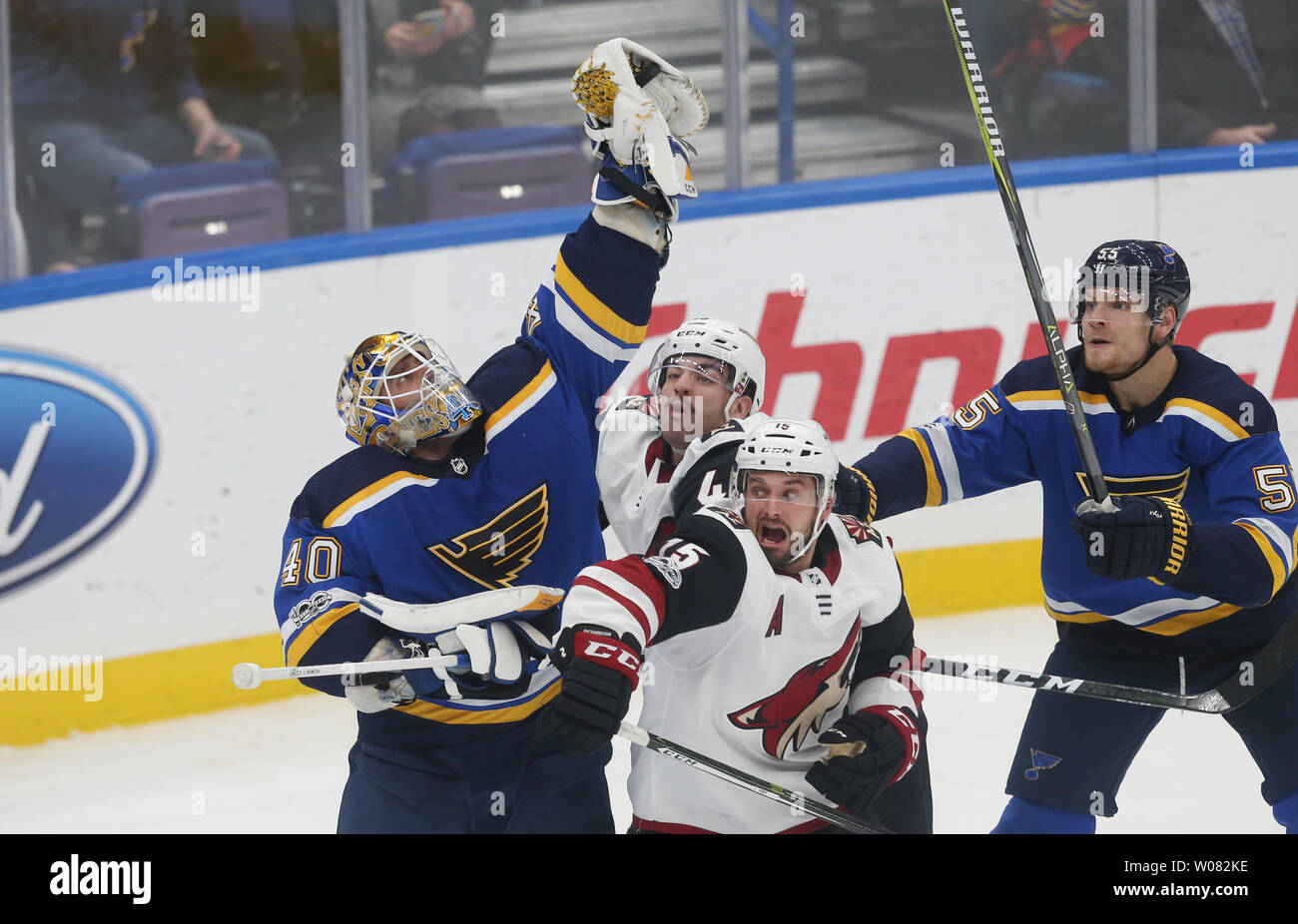 St. Louis Blues goaltender Carter Hutton reaches for the puck over the heads of Arizona Coyotes Brad Richardson (15) and Jordan Martinook in the third period at the Scottrade Center in St. Louis on November 9, 2017. St. Louis defeated Arizona 3-2 in a shootout.    Photo by Bill Greenblatt/UPI Stock Photo
