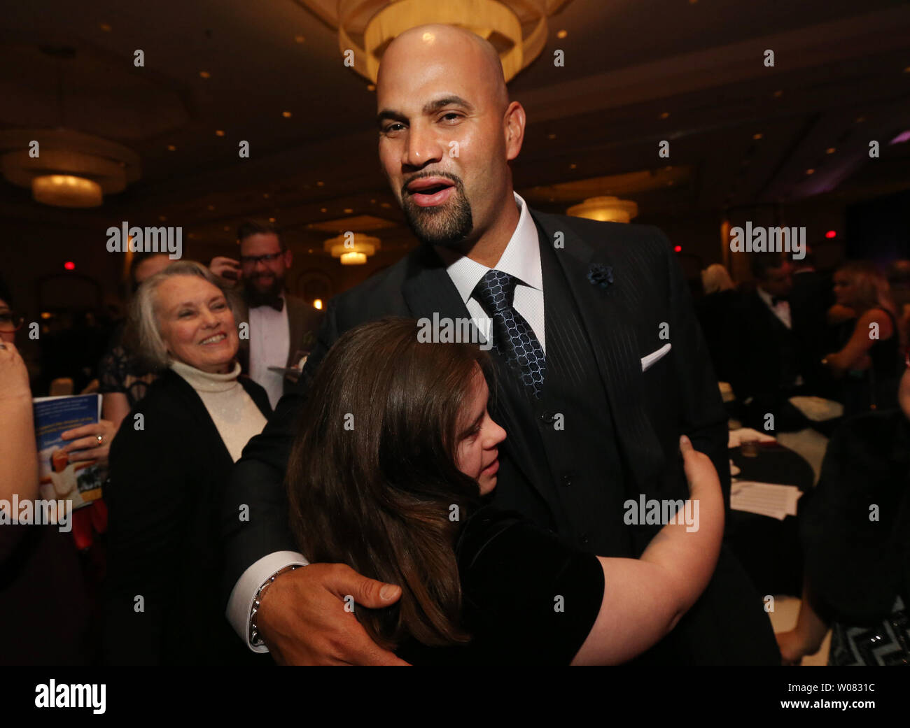 Los Angeles Angels Albert Pujols greets young fan Rachel Randolph during the Pujols Family Foundation O' Night Devine in St. Louis on December 9, 2017. The annual Christmas event assists the families with children with Down syndrome and tries to improve the lives of the improverished in the Dominican Republic.    Photo by Bill Greenblatt/UPI Stock Photo