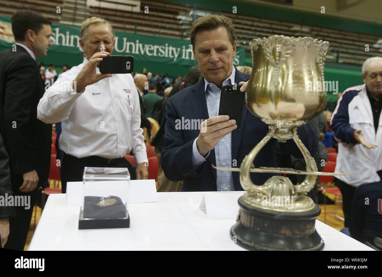 Attendees at Washington University photograph the National Regatta Trophy won by the St. Louis Rowing Club at the 1904 Olympics following a press conference at Washington University in St. Louis on on February 5, 2018.  It was announced that an Olympic Legacy Committee has been formed that will remember the Summer Olympics that were held at the campus in 1904. The project has beeen approved by the International Olympic Committee which will allow the display of the Olympic Rings. St. Louis is one of only 23 cities in the world and three in the United States to host the summer games. The goal of Stock Photo