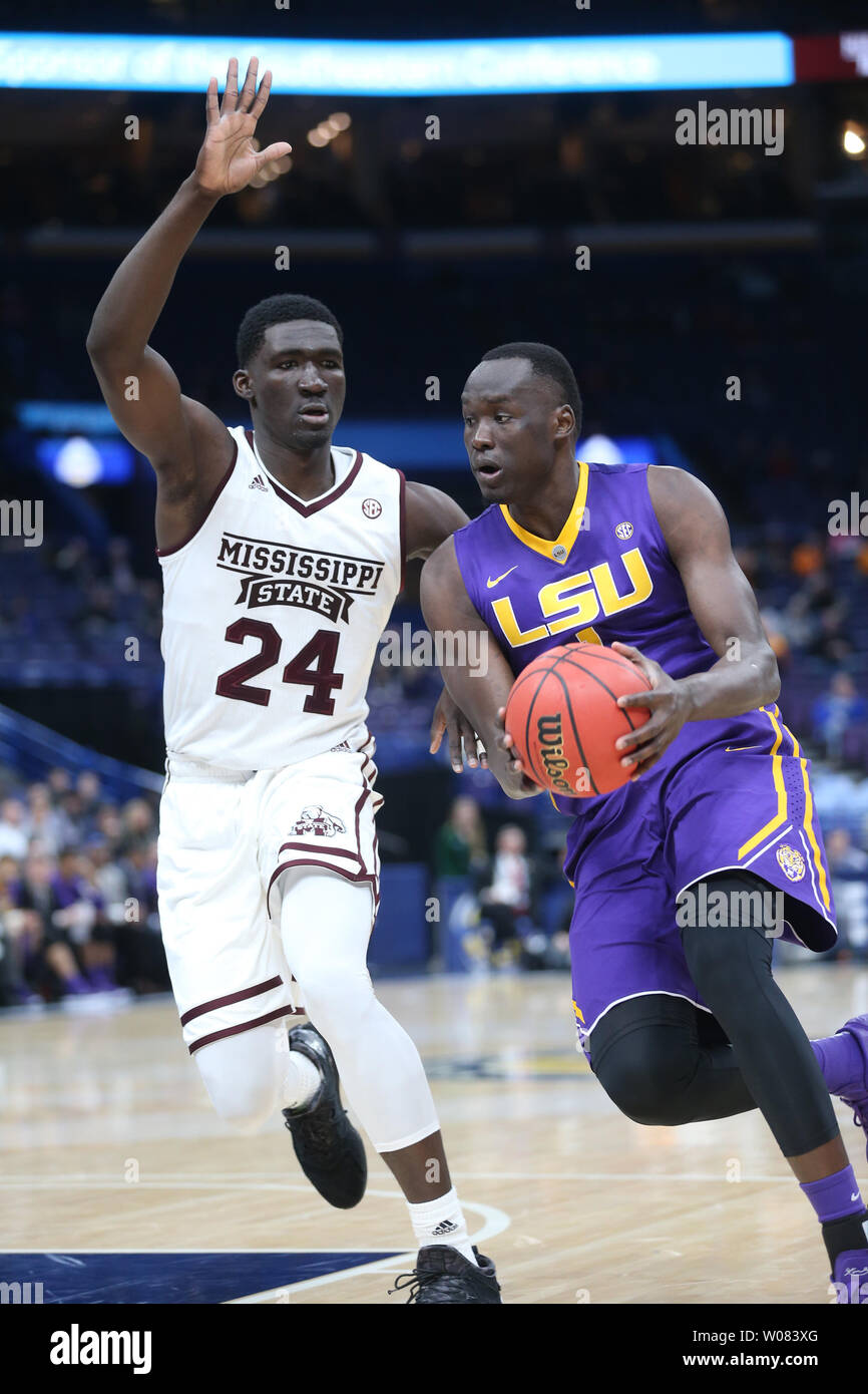 LSU's Duop Reath drives past Missisippi State's Abdul Ado in the first half  of their SEC Tourament game at the Scottrade Center in St. Louis on March  8, 2018. Photo by BIll