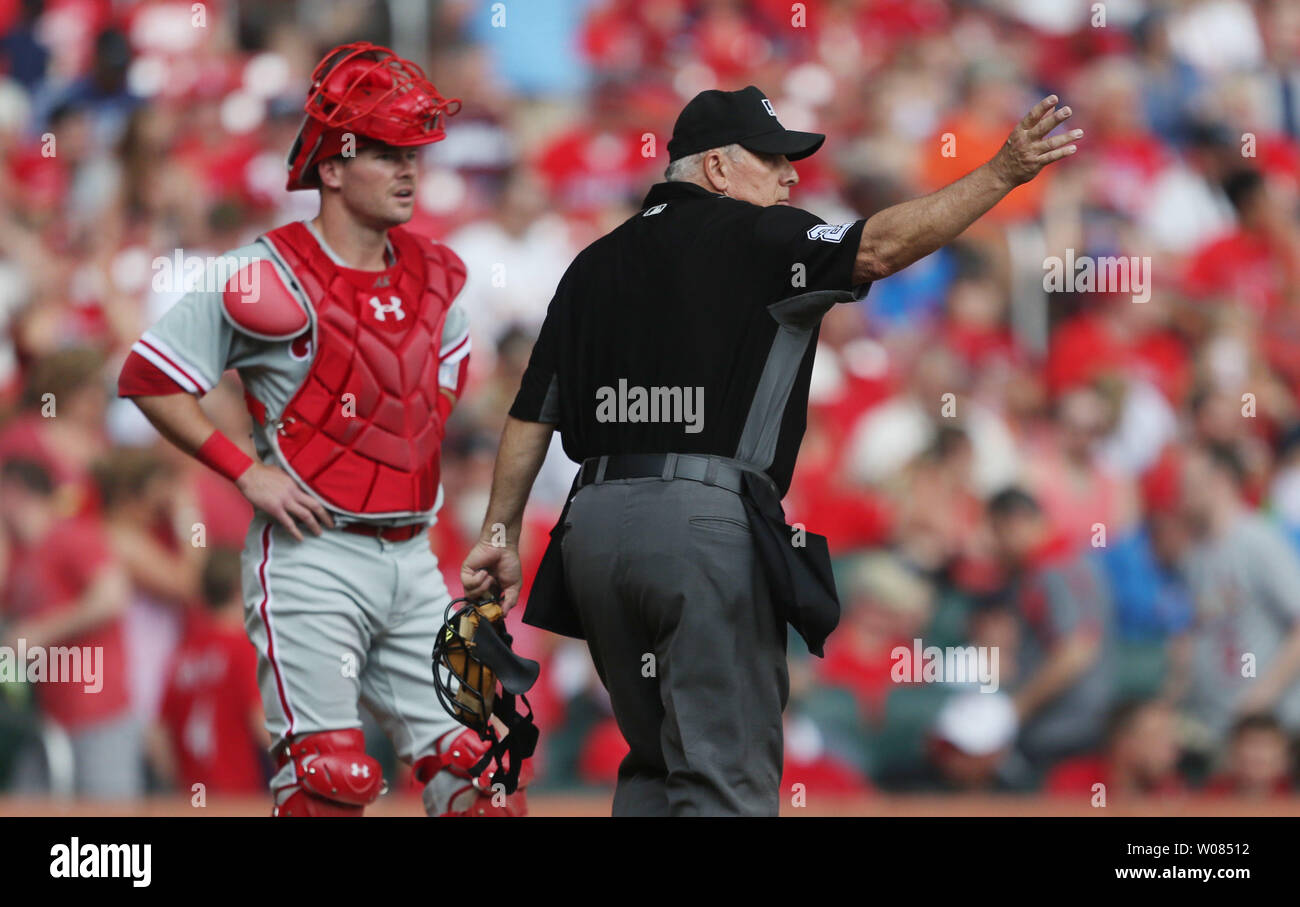 Umpire crew chief Larry Vanover clears the field as Philadelphia