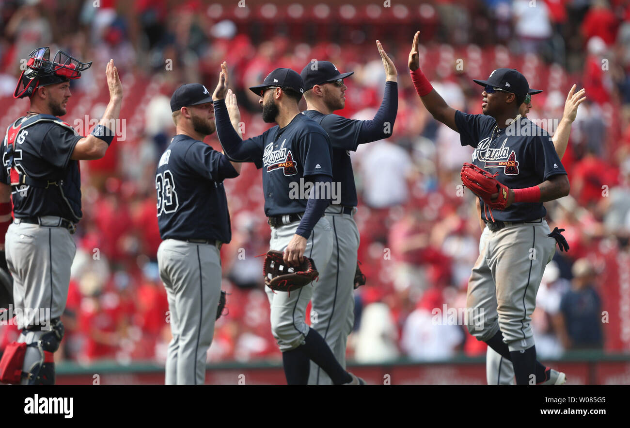 Members of the Atlanta Braves slap hands as they celebrate a 6-5 win ...