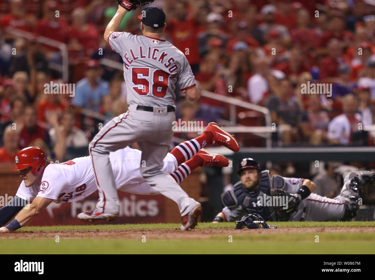 Washington Nationals starting pitcher Jeremy Hellickson can only watch as St. Louis Cardinals Harrison Bader dives safely into home plate after a pass ball in the fifth inning at Busch Stadium in St. Louis on August 15, 2018. Looking on is catcher Spencer Kieboom.  Photo by Bill Greenblatt/UPI Stock Photo