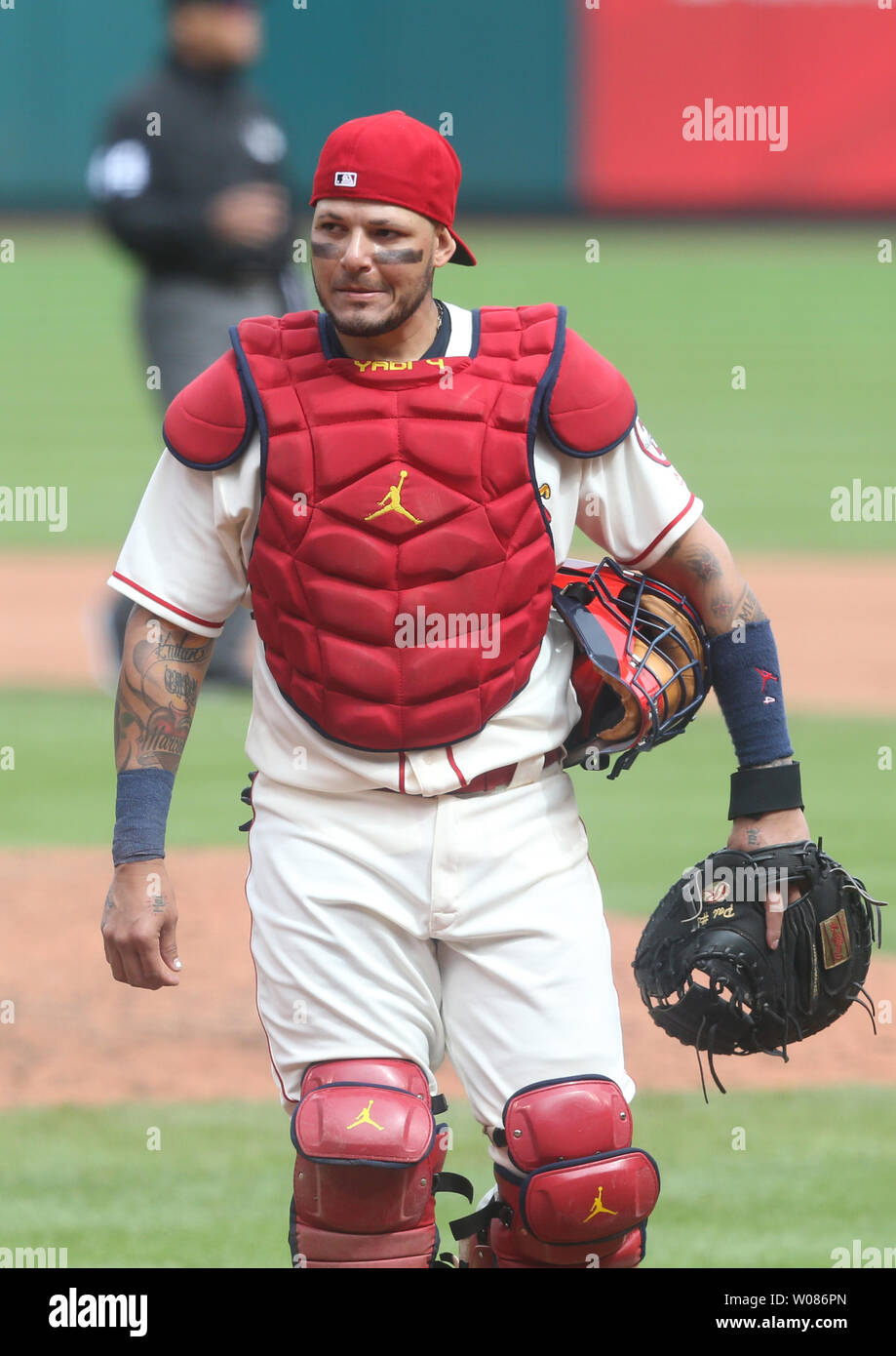 St. Louis Cardinals catcher Yadier Molina walks back to position after a  mound visit with starting pitcher Adam Wainwright in the seventh inning  against the San Francisco Giants at Busch Stadium in
