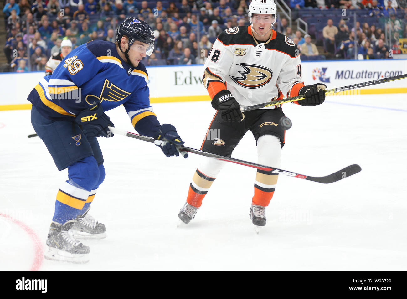 St. Louis Blues Ivan Barbashev of Russia and Anaheim Ducks Isac Lundestrom of Sweden, battle for airborne puck in the first period at the Enterprise Center in St. Louis on October 14, 2018.   Photo by Bill Greenblatt/UPI Stock Photo