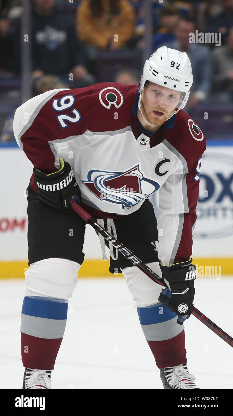 Former Montreal Canadien Ralph Backstrom presents Colorado Avalanche  captain Gabriel Landeskog the Calder Memorial trophy for winning rookie of  the year before the first period at the Pepsi Center on January 22