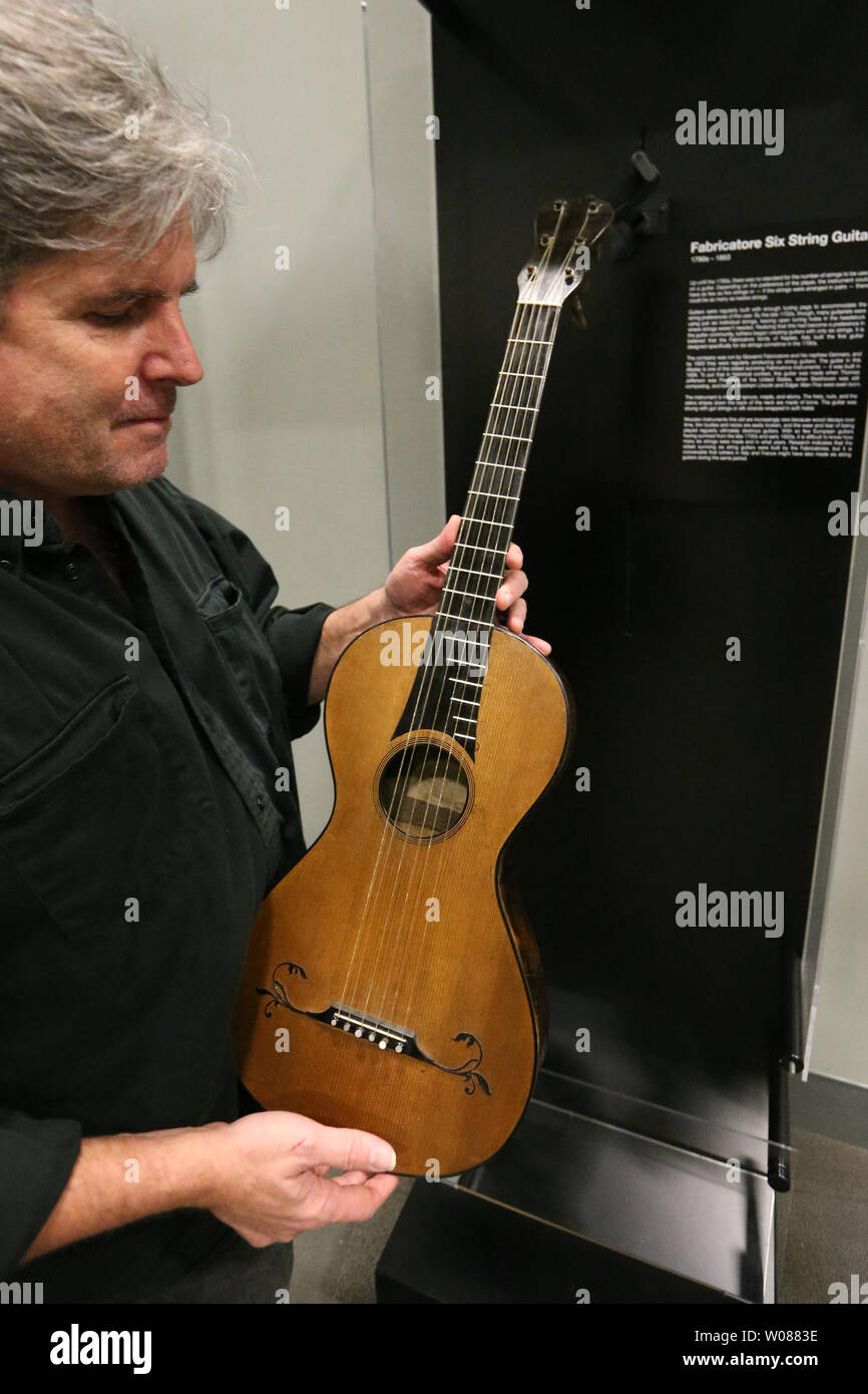 H.P. Newquist, Director of the National Guitar Museum, inspects a rare