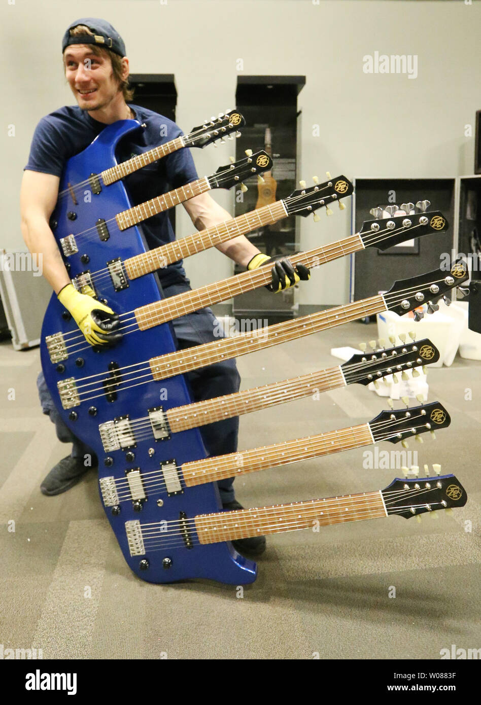 Installer Collin Thomas of St. Louis tries his hand at playing the