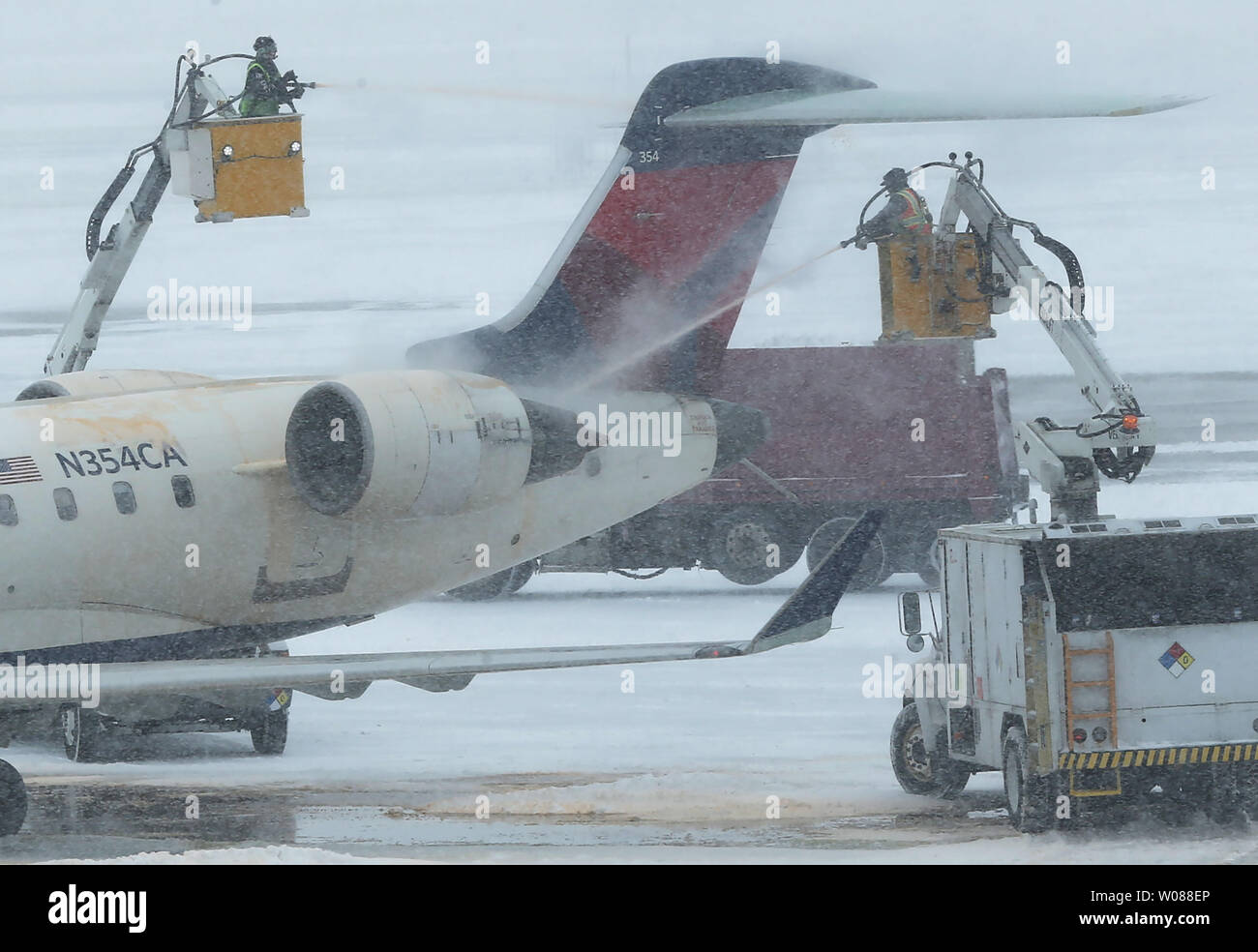 A plane is sprayed with de-icing fluid before take off during a heavy snow storm at St. Louis-Lambert International Airport in St. Louis on March 3, 2019. The morning storm dumped 2-3 inches on the area. Photo by Bill Greenblatt/UPI Stock Photo