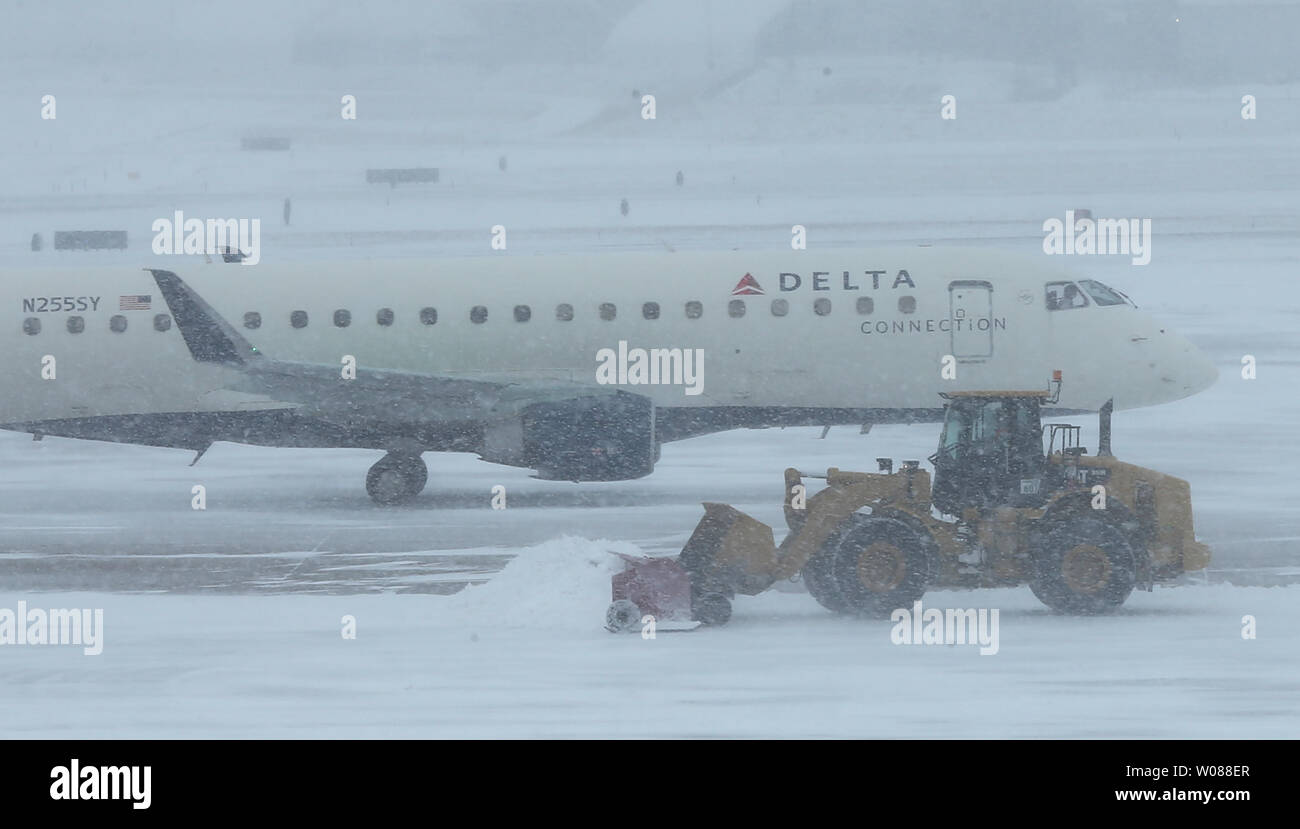 A Delta plane taxis to a gate as equiptment attempts to clear the runways during a heavy snow storm at St. Louis-Lambert International Airport in St. Louis on March 3, 2019. The morning storm dumped 2-3 inches on the area. Photo by Bill Greenblatt/UPI Stock Photo
