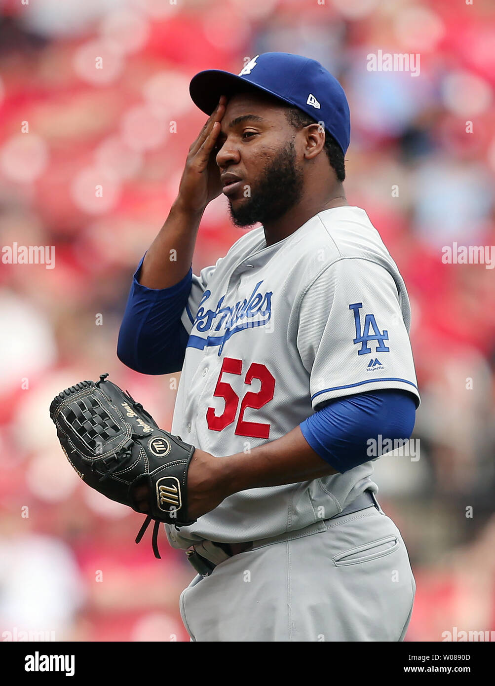Los Angeles Dodgers pitcher Pedro Baez wipes his face after hitting St