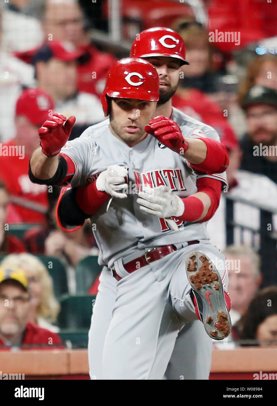 Cincinnati Reds Joey Votto kicks his leg up as teammate Jesse Winkler holds onto him after Votto hit a solo home in the fifth inning against the St. Louis Cardinals at Busch Stadium in St. Louis on April 26, 2019. Photo by Bill Greenblatt/UPI Stock Photo