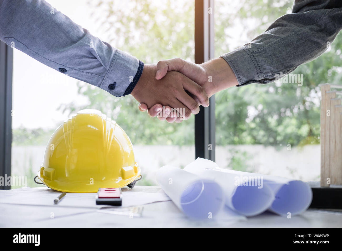 Shaking hands of collaboration, Construction engineering or architect