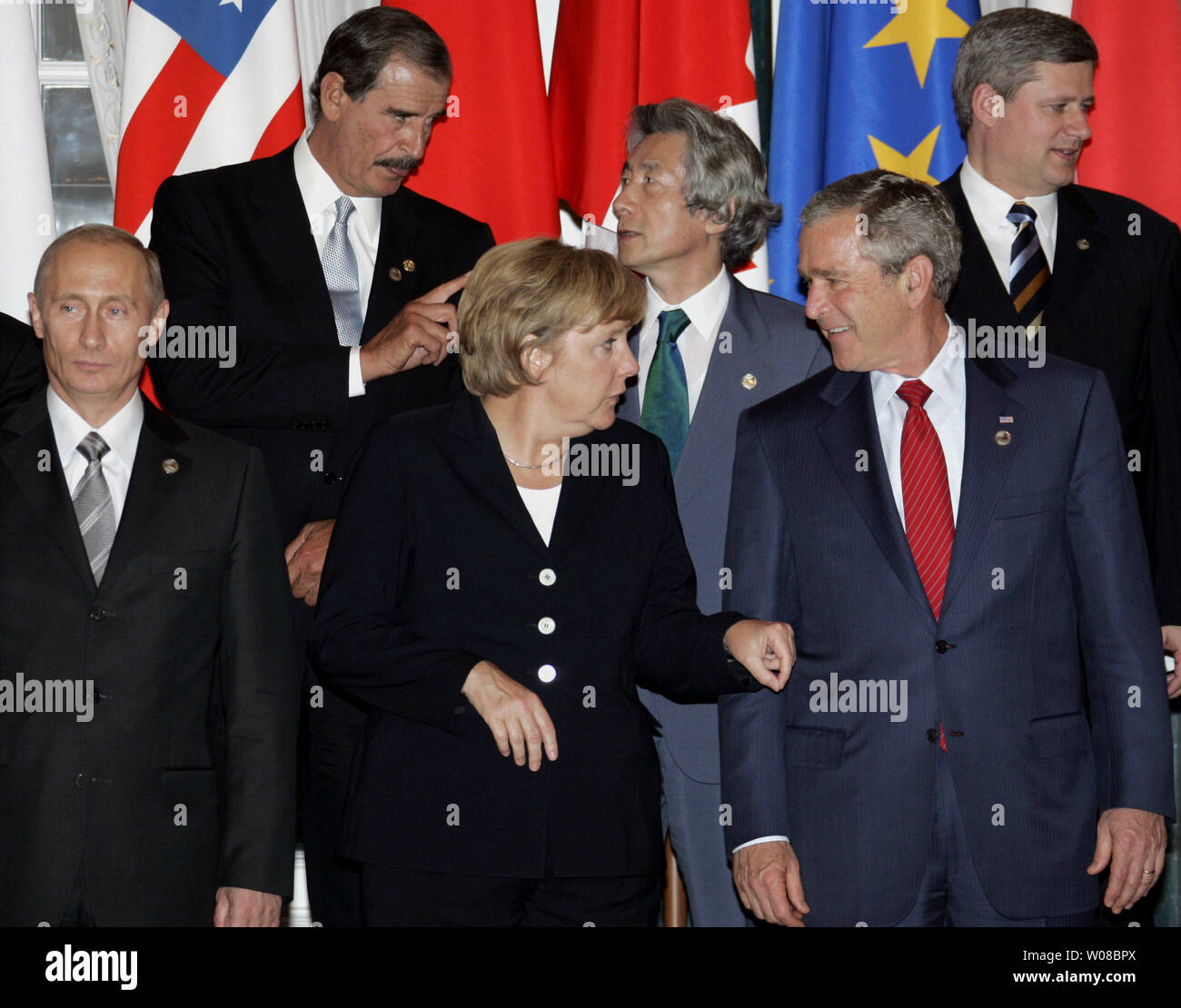 Bottom left to right: , German Chancellor Angela Merkel (C) talks to U.S. President George W. Bush as Russian President Vladimir Putin (L) looks on during a G8 leaders group photo following the final session of the G8 Summit in Saint Petersburg, Russia on July 17, 2006. Also pictured on the top row left to right: Mexican President Vicente Fox, Japanese Prime Minister Junichiro Koizumi and Canadian Prime Minister Stephen Harper. (UPI Photo/Anatoli Zhdanov) Stock Photo