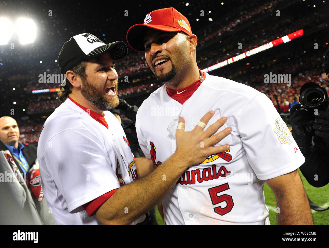 St. Louis Cardinals Lance Berkman embraces Albert Pujols after the Cardinals  won the 2011 World Series in St. Louis on October 28, 2011. The Cardinals  defeated the Texas Rangers 6-2 winning game